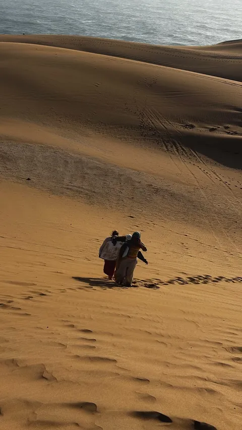 Walking across the sand dunes on a retreat day trip