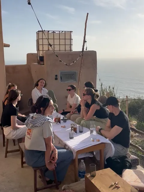 Retreat dinner at a long table on the terrace