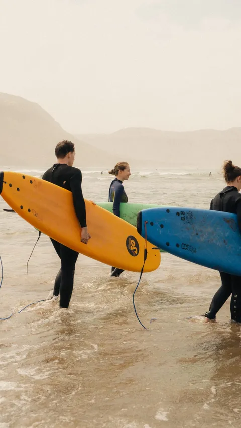 Surfers paddling out together in Imsouane